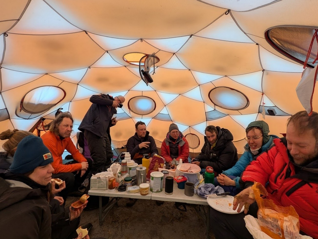 Sharing food and stories in the mess tent. (Photo: Liz Bagshaw)